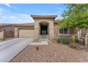 Charming single-story home featuring a desert-scape front yard and covered porch under a beautiful blue sky at 25202 N 106Th Dr, Peoria, AZ 85383