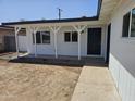 Inviting covered front porch featuring white columns, manicured landscape and a stylish front door at 2833 W Marlette Ave, Phoenix, AZ 85017