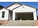 Spacious two-car garage with an open door and freshly poured concrete driveway, awaiting your personal touches at 29761 N Oak Dr, Florence, AZ 85132