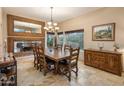 Elegant dining room with a large wooden table, decorative mirror, and natural light from the windows at 30330 N 77Th Pl, Scottsdale, AZ 85266