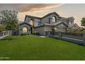Stunning two-story home showcasing lush green lawn, and three-car garage, creating an inviting curb appeal at 3202 E Orange Dr, Phoenix, AZ 85018