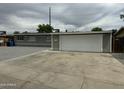 Side view of a single story house with a long driveway to a two-car garage at 3608 W Hazelwood St, Phoenix, AZ 85019