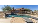 Backyard pool with a waterfall feature and a patio with lounge chairs offering a relaxing outdoor space at 3720 E Vista Grande --, San Tan Valley, AZ 85140