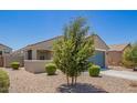 Well-maintained home with desert landscaping, a two-car garage, and a cozy front porch at 40441 W Hillman Dr, Maricopa, AZ 85138
