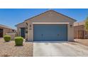 Inviting single-story home featuring a two-car garage, desert landscaping, and a covered front entry at 40441 W Hillman Dr, Maricopa, AZ 85138
