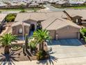 Stunning single-story home with desert landscaping, tile roof, and a spacious three car garage at 42293 W Good Vibrations Ln, Maricopa, AZ 85138