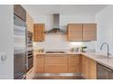 Bright modern kitchen features light wood cabinets, stainless steel appliances, and a functional layout at 4747 N Scottsdale Rd # 4003, Scottsdale, AZ 85251
