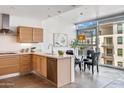 Stylish kitchen featuring stainless appliances and a modern faucet with a dining area adjacent to a large window at 4747 N Scottsdale Rd # 4003, Scottsdale, AZ 85251