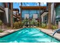Inviting community pool, lined with palm trees and lush desert landscaping, offers a serene oasis at 4747 N Scottsdale Rd # 4003, Scottsdale, AZ 85251