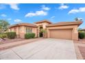 Charming single-story home with a well-manicured yard, concrete driveway and a tile roof at 4756 E Ironhorse Rd, Gilbert, AZ 85297
