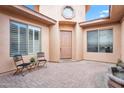 Cozy courtyard with neutral stucco walls, brick floor, and a charming water fountain feature at 4756 E Ironhorse Rd, Gilbert, AZ 85297