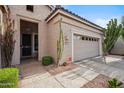 A single-story home featuring a tiled roof, two-car garage, desert landscaping, and a covered entryway at 4819 E Villa Theresa Dr, Scottsdale, AZ 85254