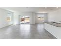 Bright living room with tiled floors, large windows, and seamless access to the backyard through sliding glass doors at 5053 E Umber Rd, San Tan Valley, AZ 85143
