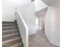 Bright staircase with carpeted steps leading to the open-concept layout, featuring neutral tile floors at 5053 E Umber Rd, San Tan Valley, AZ 85143