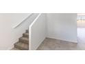 Carpeted staircase features a white handrail complementing the walls in this modern home at 5053 E Umber Rd, San Tan Valley, AZ 85143
