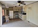 Cozy kitchen featuring essential appliances, cabinets, and flooring at 61 W Southern Ave # 63, Mesa, AZ 85210