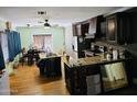 Open kitchen and dining area with dark wood cabinetry, granite countertops, and hardwood floors at 723 E Moreland St, Phoenix, AZ 85006