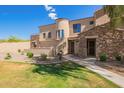 Charming home featuring stone accents, a tiled roof, a landscaped yard, and well manicured desert landscaping at 7445 E Eagle Crest Dr # 1061, Mesa, AZ 85207