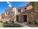 Charming home featuring stone accents, a tiled roof, a landscaped yard, and well manicured desert landscaping at 7445 E Eagle Crest Dr # 1061, Mesa, AZ 85207