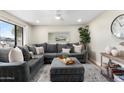 Spacious living room with a large sectional sofa, ottoman, area rug, and decorative accents at 7520 E Diamond St, Scottsdale, AZ 85257