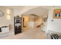 Hallway with light tile flooring, decorative mirrors, wall paneling, and access to other rooms at 7860 E Camelback Rd # 404, Scottsdale, AZ 85251
