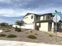 A new house is landscaped with desert style gravel and young trees at 820 W Lark Dr, Queen Creek, AZ 85140