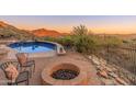 Beautiful pool and firepit area with desert landscaping and mountain views at 11550 E Paradise Ln, Scottsdale, AZ 85255