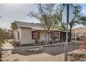 Charming single-story home with covered front porch and chain link fence at 1438 S 112Th Ave, Avondale, AZ 85323