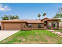 Inviting home featuring a red tile roof, well-manicured lawn, and desert landscaping with mountain views at 15430 N 19Th Way, Phoenix, AZ 85022