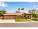 Inviting home featuring a red tile roof, well-manicured lawn, and desert landscaping with mountain views at 15430 N 19Th Way, Phoenix, AZ 85022