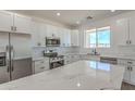 Bright kitchen features marble countertops, stainless appliances, white cabinets, and ample counter space at 16025 E Rancho Laredo Dr, Scottsdale, AZ 85262