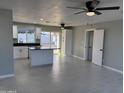 Bright open-concept living room and kitchen area with stylish tile floors and modern ceiling fans at 1720 W Michigan Ave, Phoenix, AZ 85023