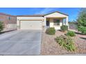Inviting single-story home with a two-car garage and meticulously landscaped front yard at 19365 N Pietra Dr, Maricopa, AZ 85138