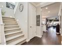Inviting entryway with staircase, wood floors, neutral colors, and a view of the living spaces at 1952 W Yellowstone Way, Chandler, AZ 85248