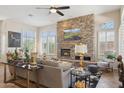 Inviting living room with a stunning stone fireplace and large windows at 1958 W Legends Way, Anthem, AZ 85086