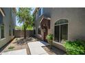 Charming townhome entrance featuring well-kept landscaping and a welcoming front door at 2150 W Alameda Rd # 1424, Phoenix, AZ 85085