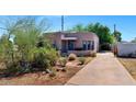 A cozy home with a desert landscape and a charming, covered front porch with blue accents at 2545 N 14Th St, Phoenix, AZ 85006