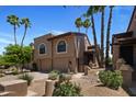 Stucco home with a tile roof, well-manicured landscaping, and a two car garage at 25609 N Forest Rd # 13, Rio Verde, AZ 85263