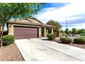 Inviting single-story home with desert landscaping and long driveway leading to a 2-car garage at 2597 E Hickory St, Gilbert, AZ 85298