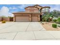 Charming home featuring a three-car garage, long driveway, and desert landscaping at 26956 N 83Rd Gln, Peoria, AZ 85383