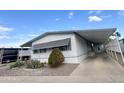 Nicely landscaped manufactured home with carport and sidewalk. Well-maintained and move-in ready at 305 S Val Vista Dr # 243, Mesa, AZ 85204