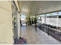 Relaxing covered patio with tiled floor, rod iron railing, table and chairs at 305 S Val Vista Dr # 243, Mesa, AZ 85204