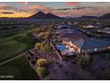 Sunset aerial view highlighting the backyard pool, patio, desert landscape, and adjacent golf course at 31108 N 122Nd Ln, Peoria, AZ 85383