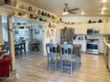 Spacious kitchen featuring white cabinets, stainless steel appliances, and an island with seating at 3231 N 81St Pl, Scottsdale, AZ 85251