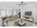 Bright, open-concept living space with hardwood floors, a ceiling fan, and modern furniture at 33731 N Bowles Dr, San Tan Valley, AZ 85144