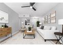 Bright living room with modern decor, ceiling fan, and view of kitchen at 3416 N 44Th St # 70, Phoenix, AZ 85018
