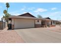 Attached two-car garage and long driveway offers lots of parking space at 350 E Huber St, Mesa, AZ 85201