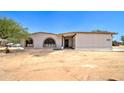 Home featuring a stucco exterior, arched windows, and desert landscaping in a tranquil setting at 35019 N Central Ave, Phoenix, AZ 85086