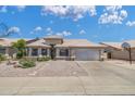 Charming single-story home with desert-style landscaping, large windows, and a spacious two-car garage at 3580 W Dublin St, Chandler, AZ 85226