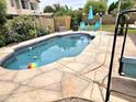 Enjoy outdoor living with this sparkling pool surrounded by a large stone patio and lush landscaping at 3580 W Dublin St, Chandler, AZ 85226